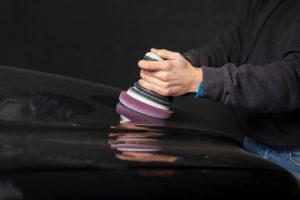 Detailing master polishes the car